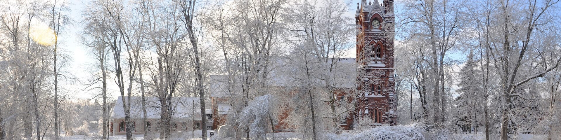 Stone Church with reflection along the river in winter, Potsdam, New York, USA
