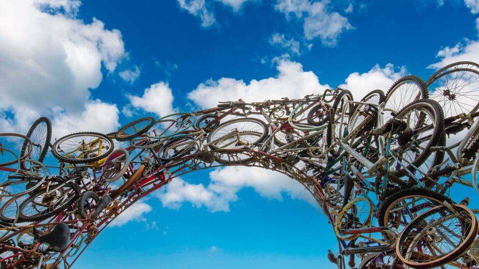 a gorgeous shot of the Bicycle Arch Sculpture with blue sky and clouds in Knoxville Tennessee USA