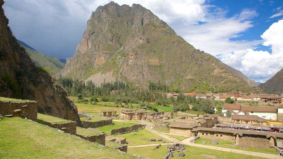 A mountainous landscape with ancient ruins and a village.