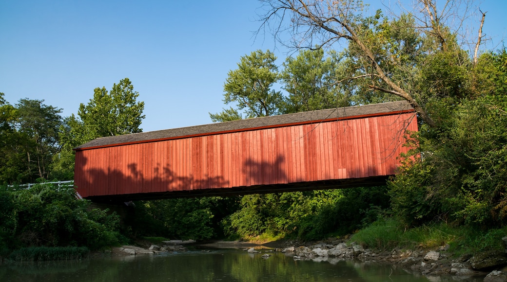 The "Red Covered Bridge" extending over the water on a Summer afternoon. Princeton, Illinois, USA