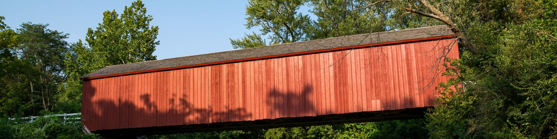 The "Red Covered Bridge" extending over the water on a Summer afternoon. Princeton, Illinois, USA