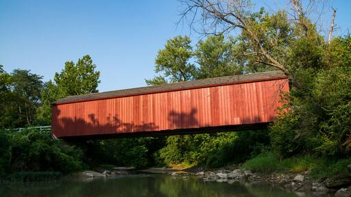 The "Red Covered Bridge" extending over the water on a Summer afternoon. Princeton, Illinois, USA