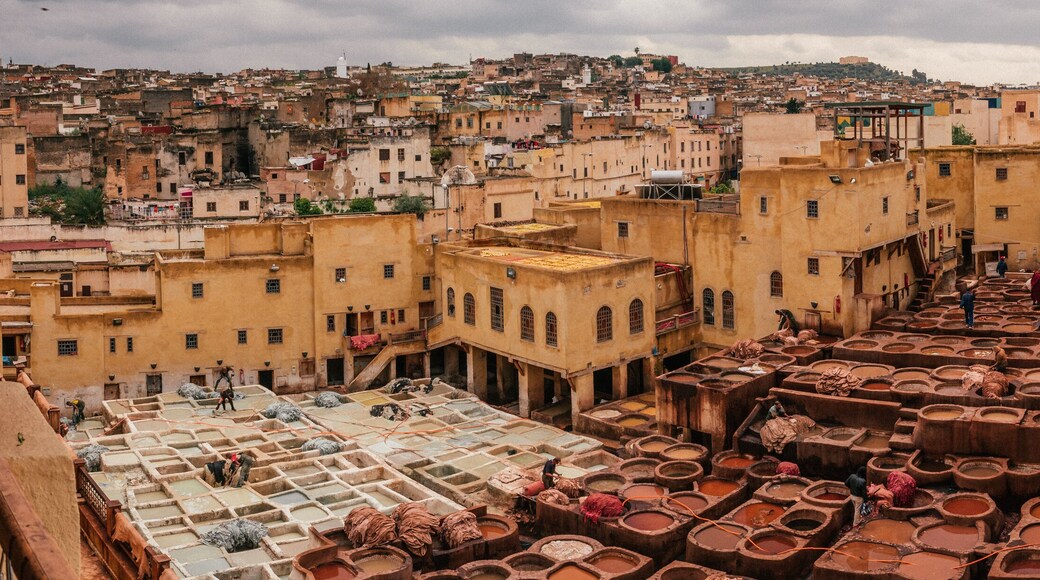 View inside of old medina in Fes, a traditional and old tannery with workers working making methods of leather in the city Fes, Morocco, in april of 2019.