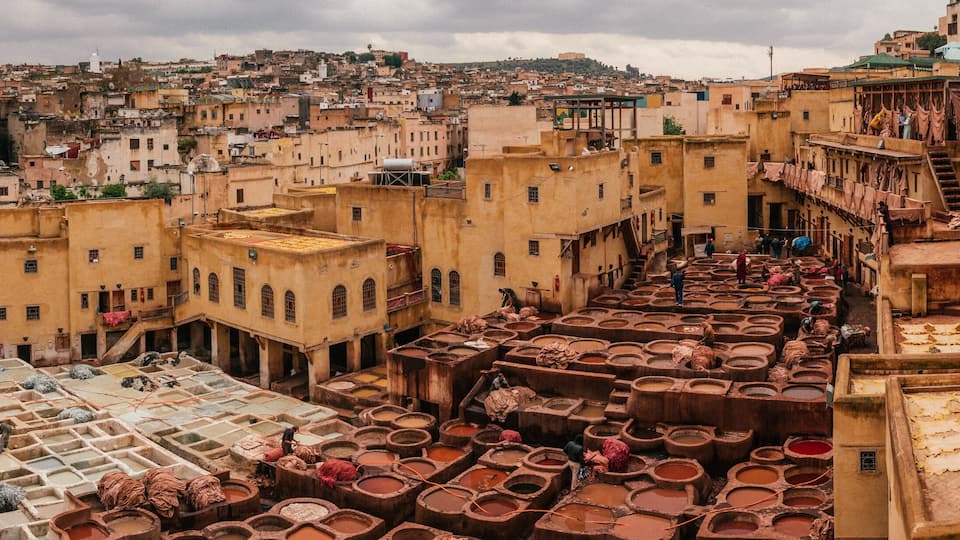 View inside of old medina in Fes, a traditional and old tannery with workers working making methods of leather in the city Fes, Morocco, in april of 2019.