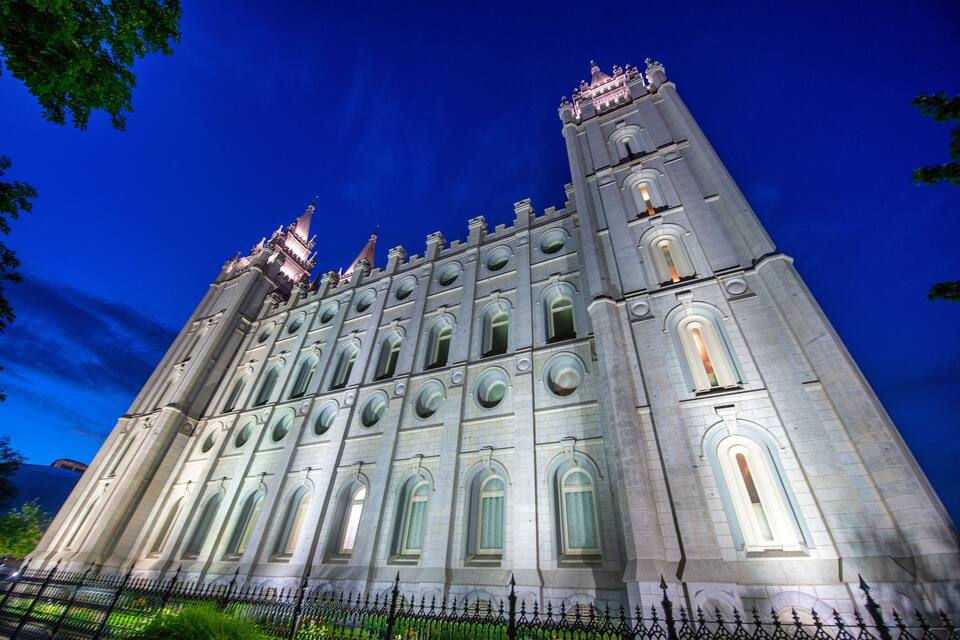 A large, ornate building with multiple towers and arched windows.