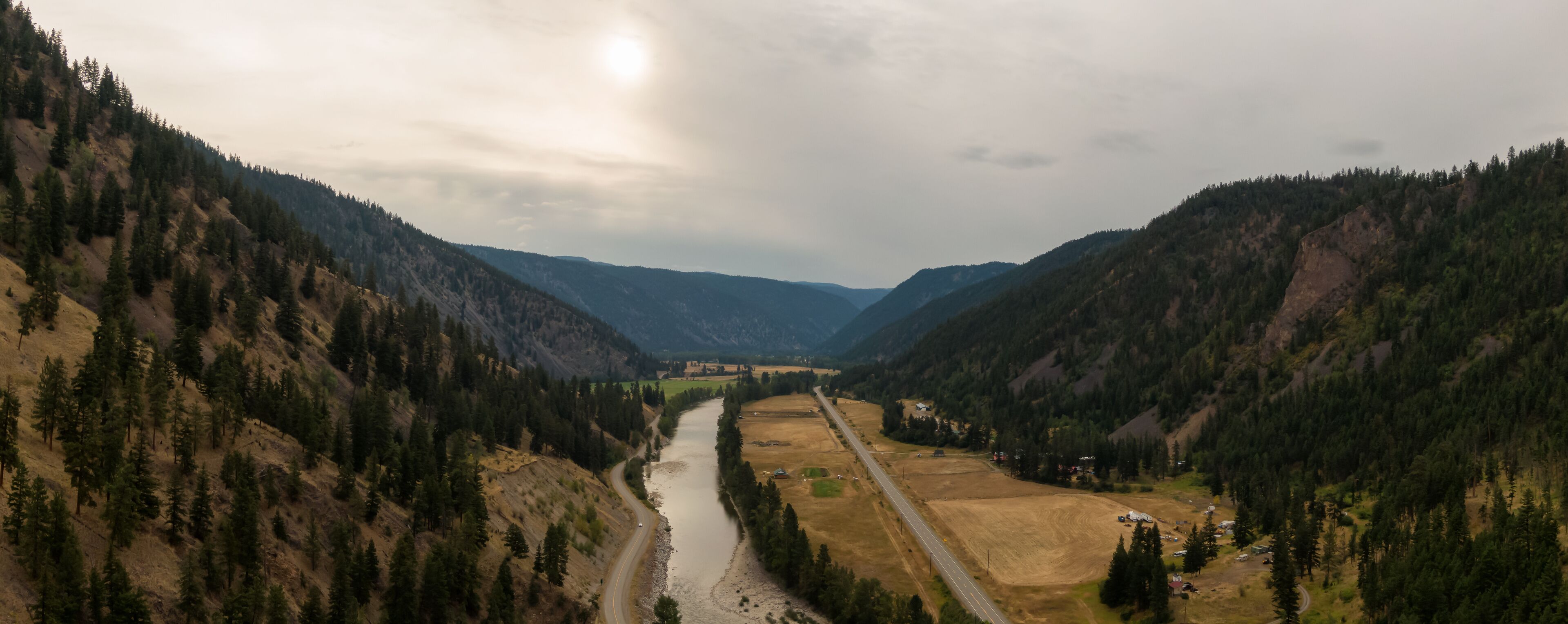 Aerial Panoramic View of a scenic Highway in the Valley surrounded by Canadian Mountain Landscape. Taken near Princeton, British Columbia, Canada.