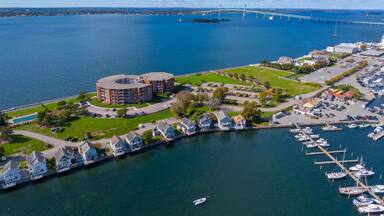Goat Island aerial view including Goat Island Marina and Newport Harbor Island Resort with Claiborne Pell Newport Bridge at the back in Narragansett Bay, Newport, Rhode Island RI, USA.