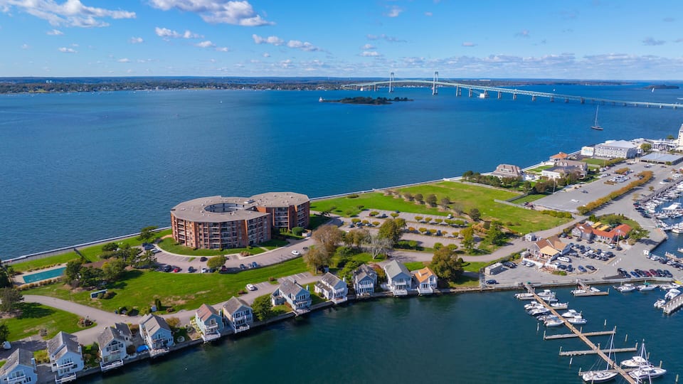 A marina with boats, a bridge, and a waterfront building.