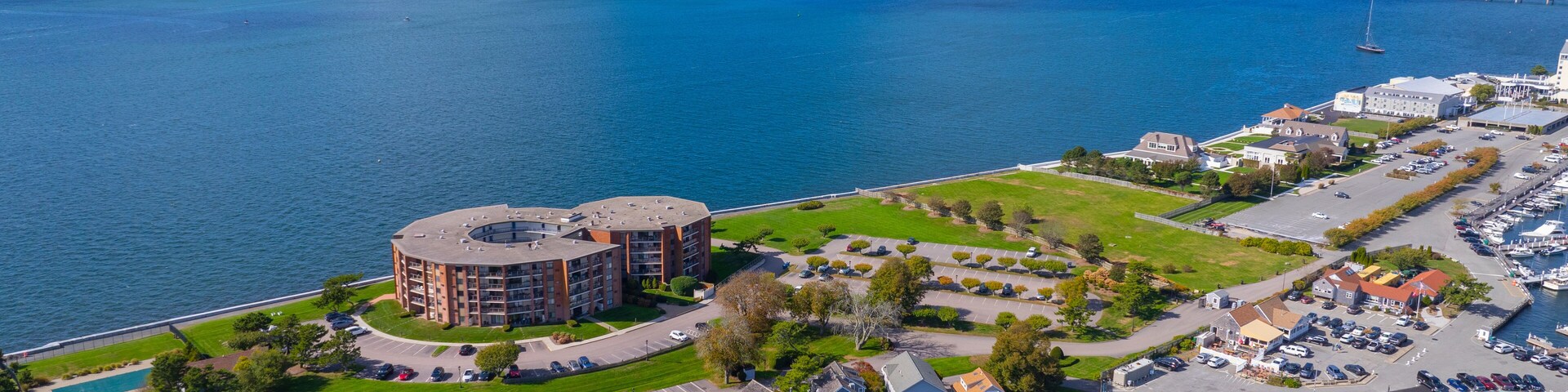 Goat Island aerial view including Goat Island Marina and Newport Harbor Island Resort with Claiborne Pell Newport Bridge at the back in Narragansett Bay, Newport, Rhode Island RI, USA.