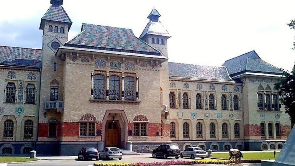 A large, ornate building with multiple towers and a central entrance.