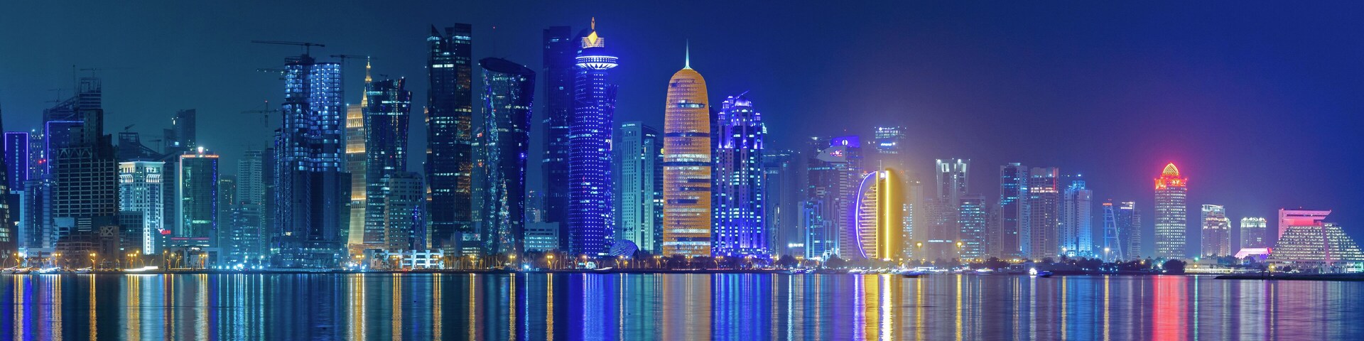 Doha, Qatar- May 5,2022 : Doha skyline with many towers during the night.