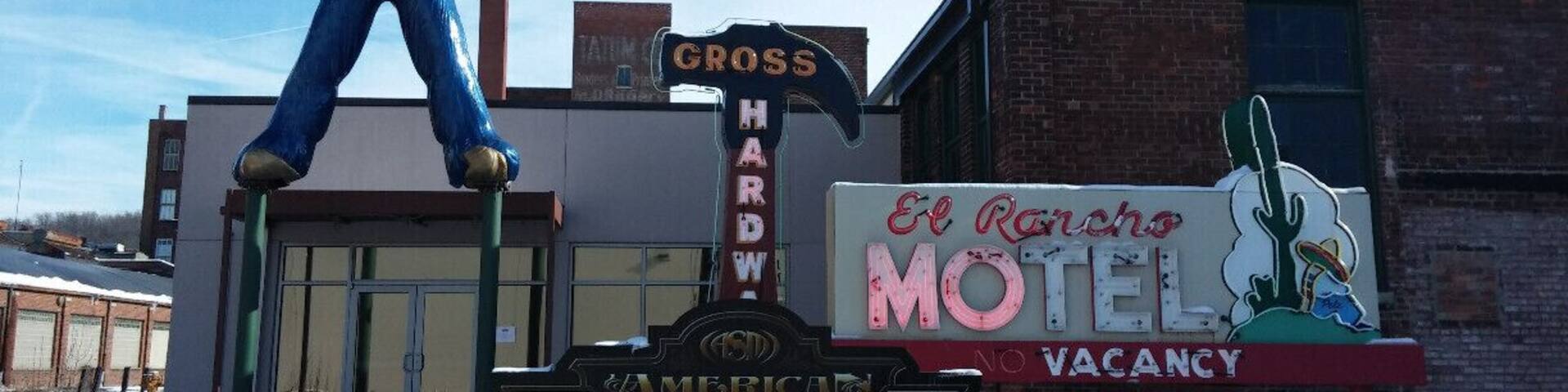 A vintage American sign, a 'Welcome' sign, and a motel sign.