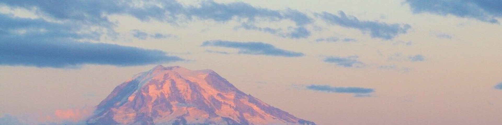 A sunset view of Mt Rainier and Thun Field from the Hangar Inn in Puyallup, WA. Its a great place to have delicious diner food (omelets, soups, sandwiches and salads), watch airplanes take-off and land while appreciating the view of the mountain. My children love coming here. We always visit on our way home from Northwest Trek.