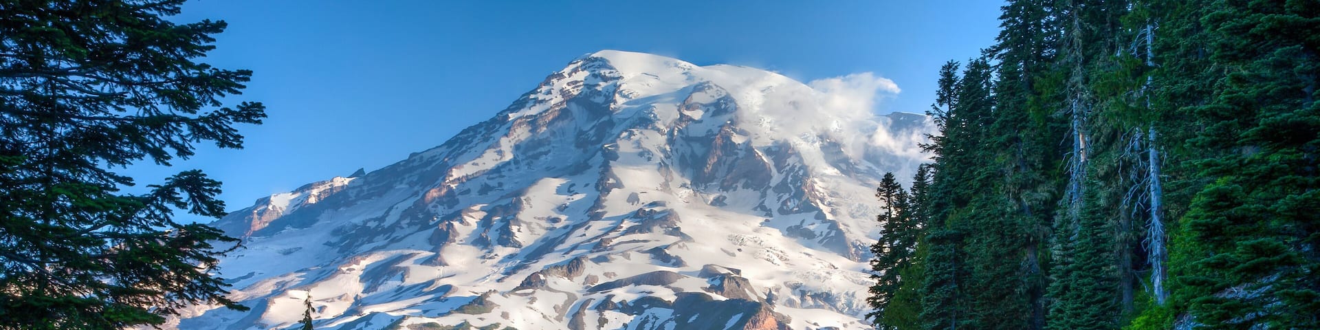 Mt Ranier and park road in Mt Ranier National Park, Washington. Glaciers and snow are visible.