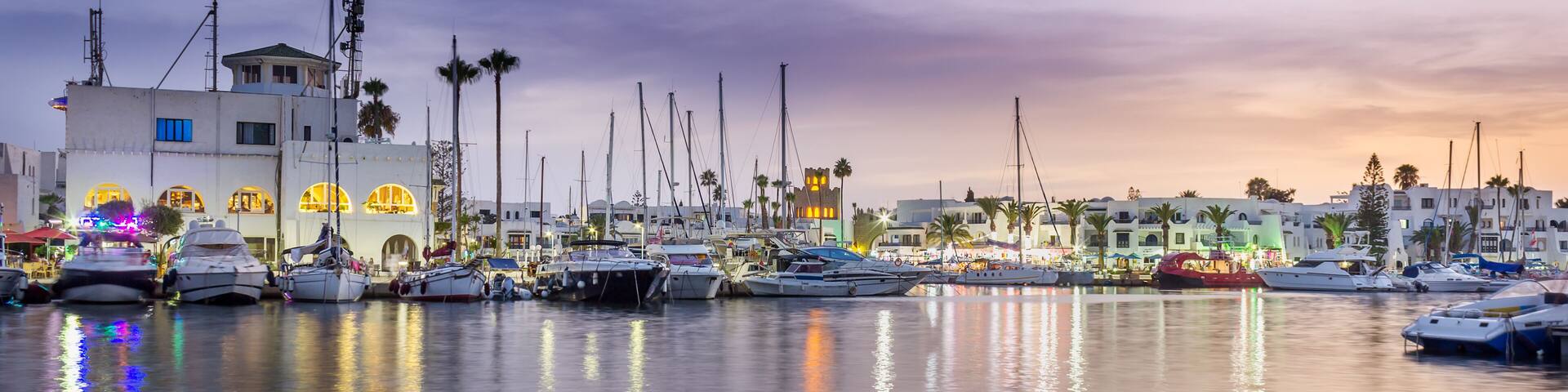 Amazing marina in Port El Kantaoui, Tunisia, colorful blue hour sky, reflections in the sea and beautiful yachts and white villas and hotels