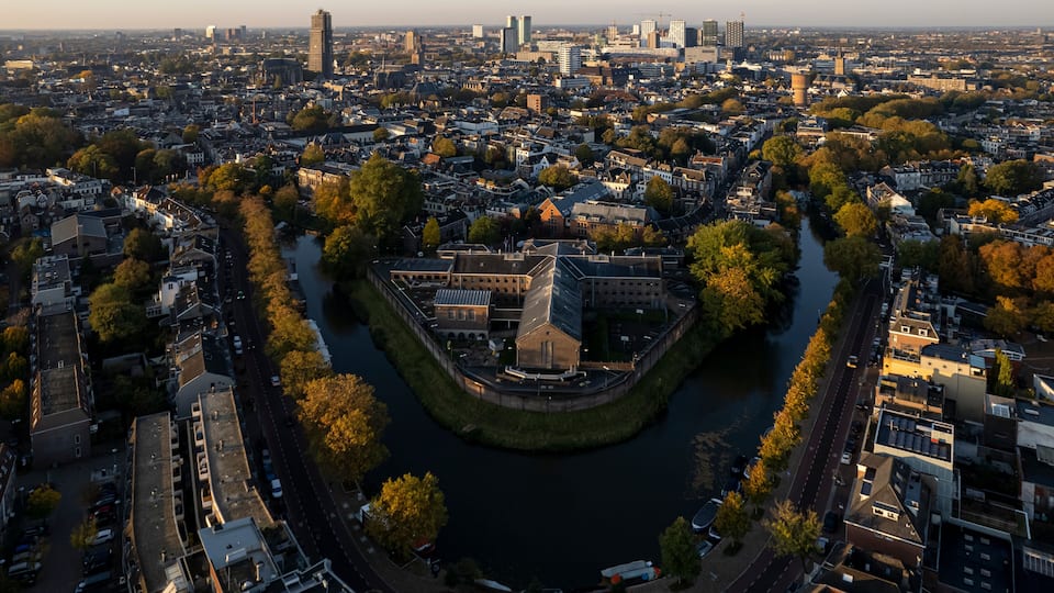 Cityscape skyline of medieval city Utrecht in The Netherlands with De Lik former prison for women in the foreground in autumn sunrise