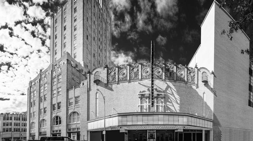 Abilene Texas city skyline and buildings and dramatic cloudscape at sunrise, black and white street landscape with view of facades of Spanish Colonial Revival architecture of theater and hotel