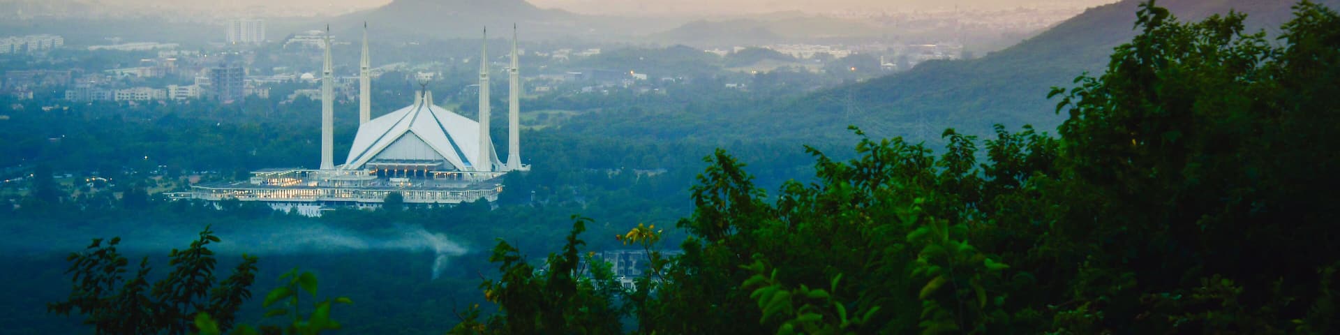 Islamabad, Pakistan - 12th september, 2023: The Faisal Mosque - fifth-largest mosque in the world. Major tourist attraction in Pakistan. Margalla hills famous sunset viewpoint panorama