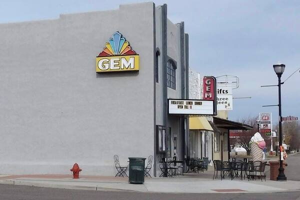 The Gem Theatre (previously known as Kinema Theatre, Hub Theatre) was built in 1909. In 1924, one of the reels of film got stuck in the projector and caught fire, igniting a full reel in the lower magazine. Only the outer shell of the theater survived the fire. The Kinema was rebuilt "as near fireproof as possible" and reopened in 1924. The Kinema Theatre was renamed the Hub Theatre in 1928. In 1933, the theatre was renovated and renamed it the Gem Theatre. After the advent of television, the theater could not attract large enough crowds to pay film rental fees. The Gem Theatre closed about 1986. The title of the last movie, Ferris Bueller's Day Off, remained on the marquee for ten years as the theater sat idle. Sometime after this the theater was again damaged by fire. Mark Childs, owner of Childs Construction, and his wife Heather, a retired dancer, purchased the Gem Theatre in April 2010, after moving to Panguitch from Henderson, Nevada. After replacing the building's fire-damaged roof, the Childs rebuilt the Gem Theatre's interior and reopened it on 28 May 2011.
#OnTheRoad
