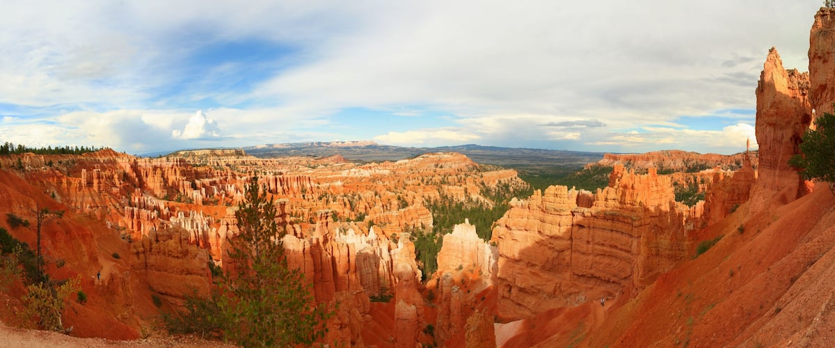 A canyon with layered rock formations and a clear sky.