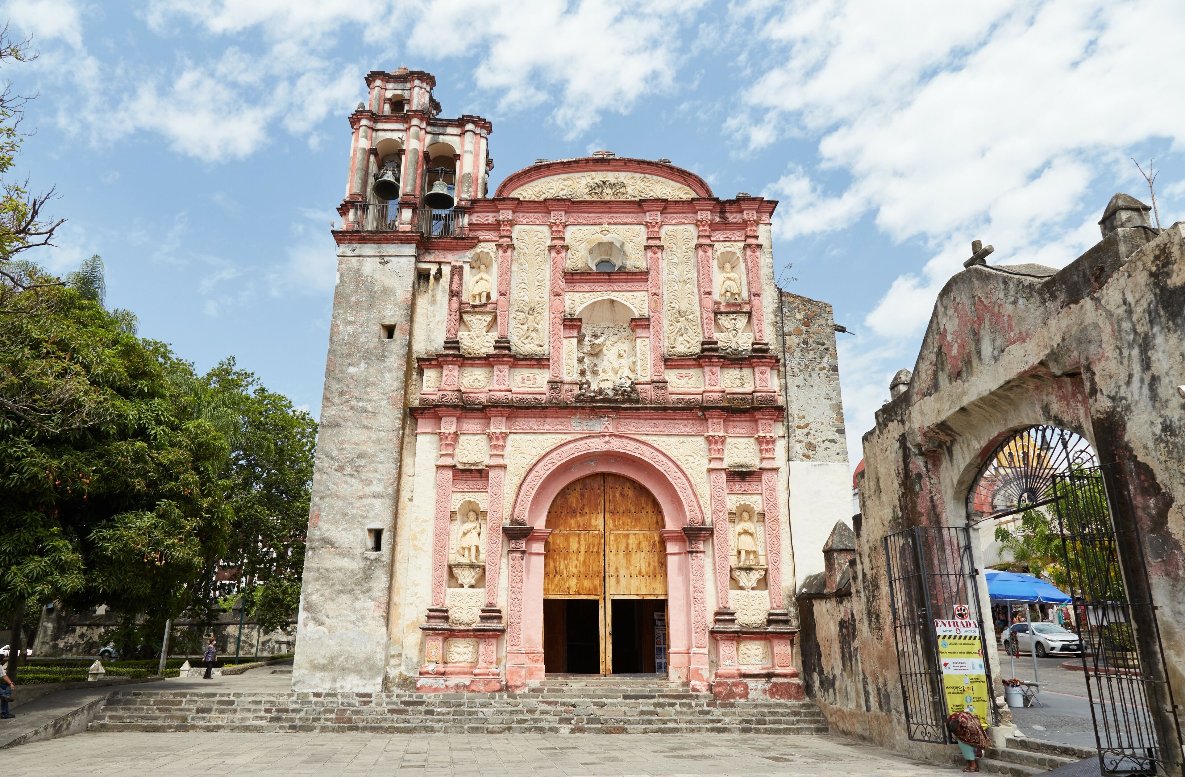 A historic church with a bell tower and arched entrance.