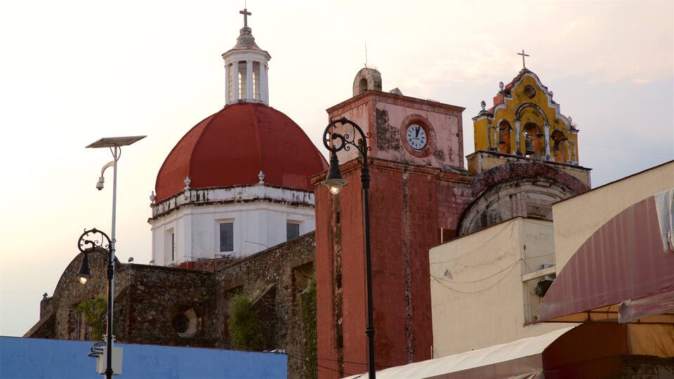 A historic church with a red dome and a clock tower.