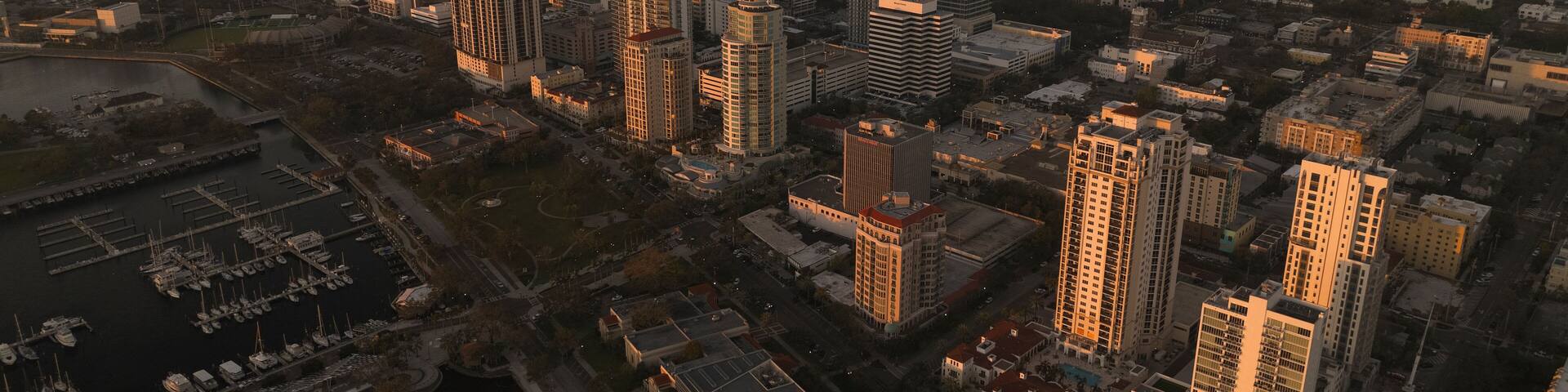Aerial view of vibrant downtown skyline with marina and pier at sunset, St. Petersburg, Florida, United States.