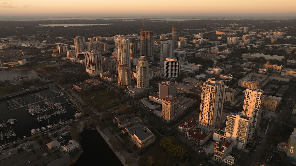 Aerial view of vibrant downtown skyline with marina and pier at sunset, St. Petersburg, Florida, United States.