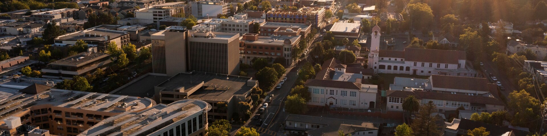 Sunset light shines on the historic Spanish Colonial mission and downtown skyline of San Rafael, California, USA.
