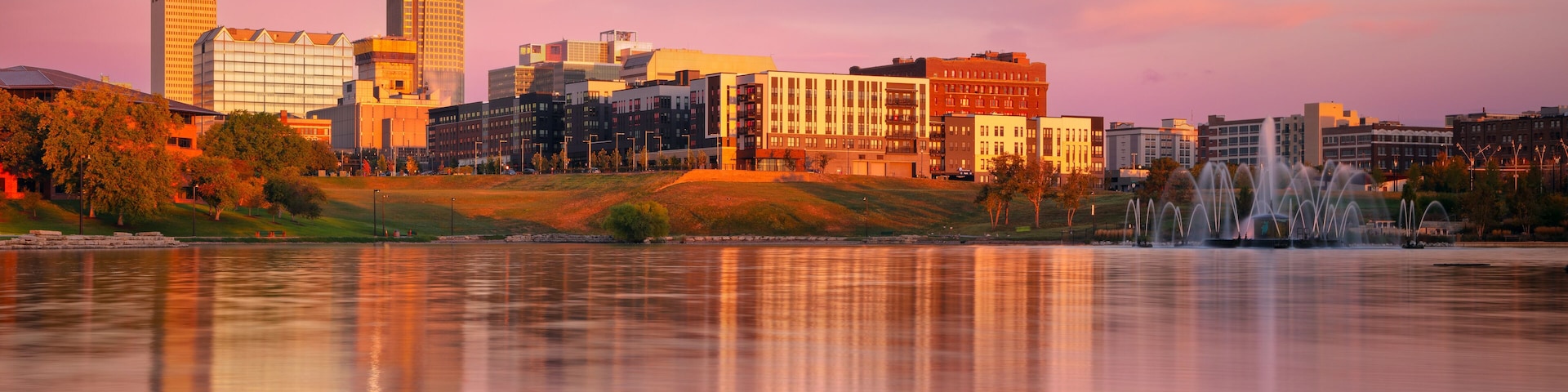 Omaha, Nebraska, USA. Cityscape image of downtown Omaha, Nebraska with reflection of the skyline at beautiful autumn sunrise.