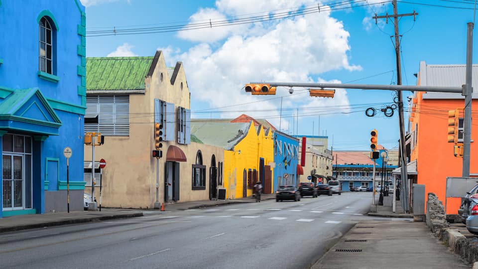 Traffic street and colorful buildings in city centre of Bridgetown, Barbados.