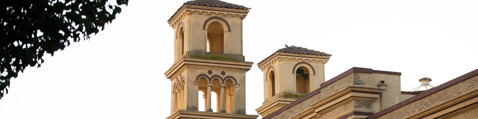 Late afternoon sun shines on the historic church and downtown of the bay area city of Alameda, California, USA.