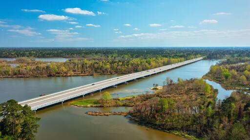 Aerial drone shot of Lake Houston with a road above in Kingwood, Texas, United States