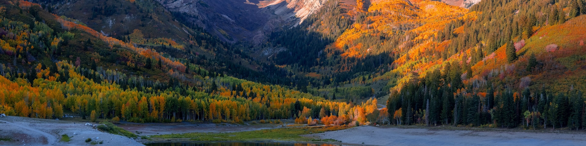 Scenic Silver lake reservoir landscape in Utah, Wasatch mountain range, under evening sunlight.