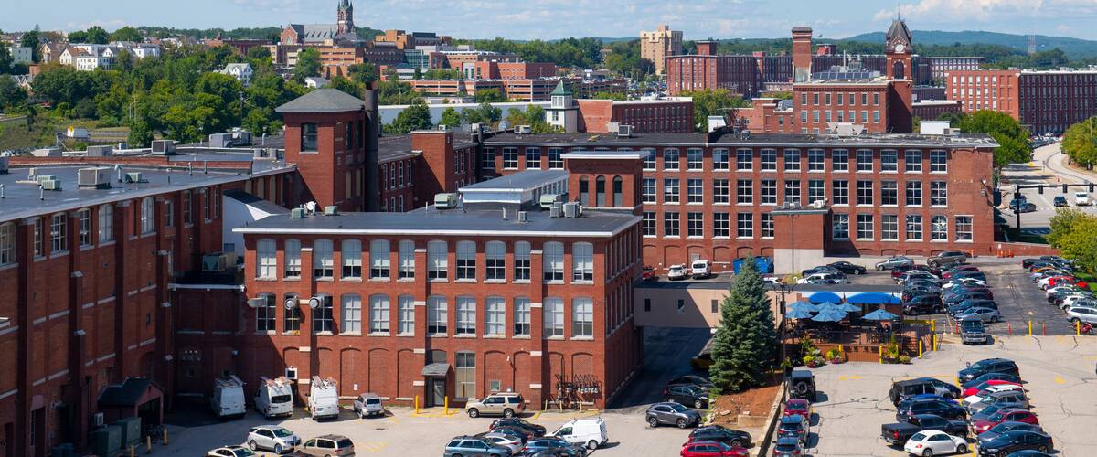 Manchester historic city skyline including Amoskeag Mill buildings and West Side Sainte Marie Parish church in Manchester, New Hampshire NH, USA.