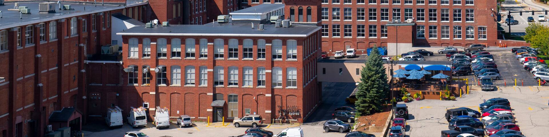Manchester historic city skyline including Amoskeag Mill buildings and West Side Sainte Marie Parish church in Manchester, New Hampshire NH, USA.