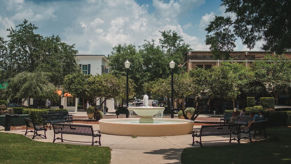 fountain in Winter Park is a city near Orlando, Florida. It’s known for its abundant outdoor spaces like leafy Central Park park avenue stock photo