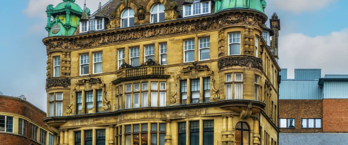 Emerson Chambers building in Newcastle City Centre featuring a copper enclosed clock on top.