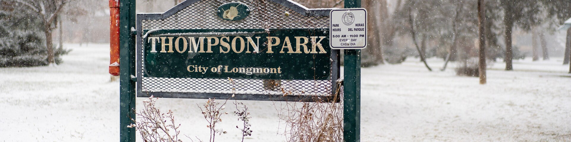 Thomson Park sign in Longmont, Colorado, covered in first winter snow