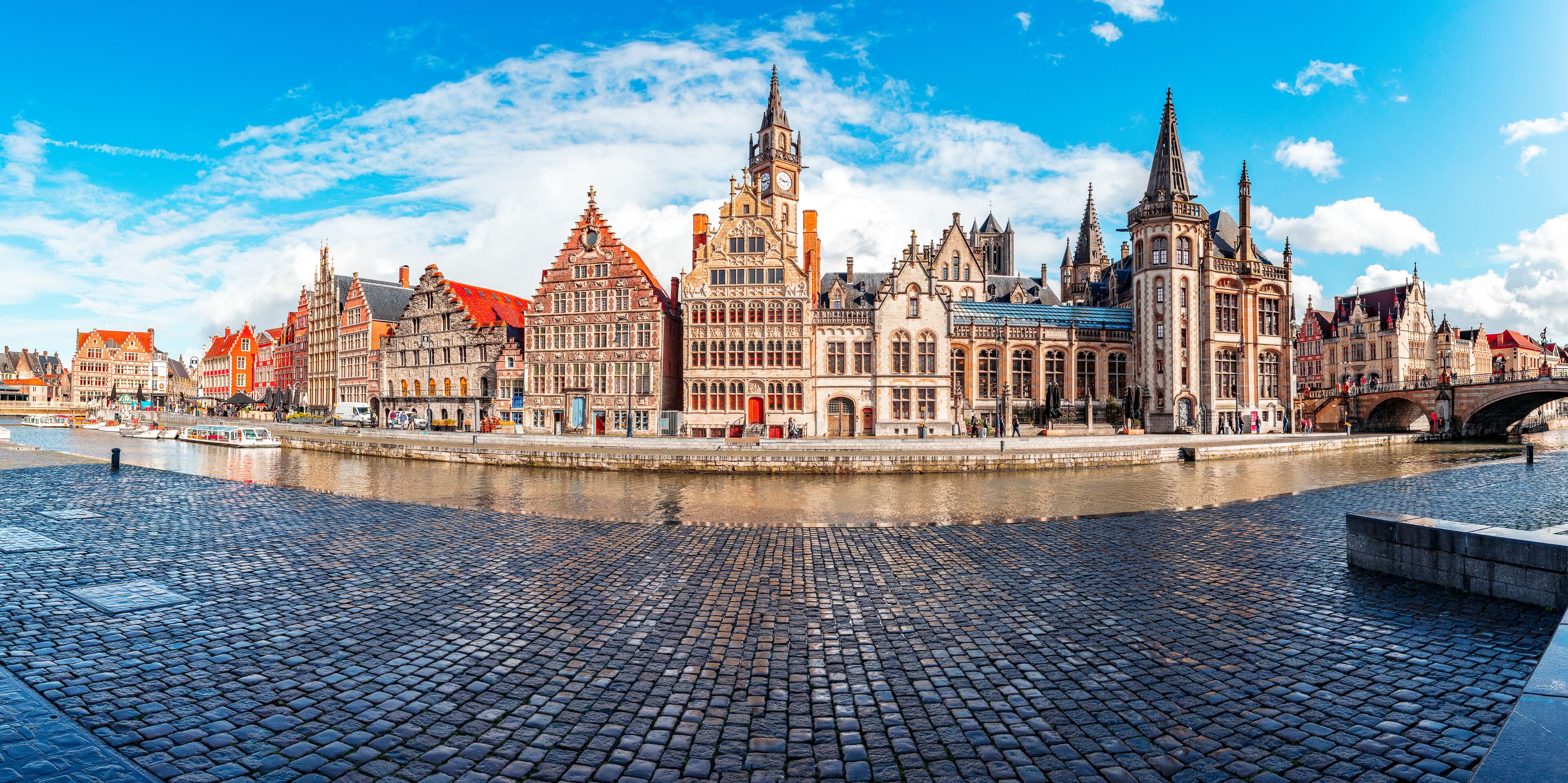 Ghent, Belgium, at sunset in spring. Historic city where you can see both Korenlei and Graslei as the river Lys (Leie) passes through the middle. Common place for tourists and students.