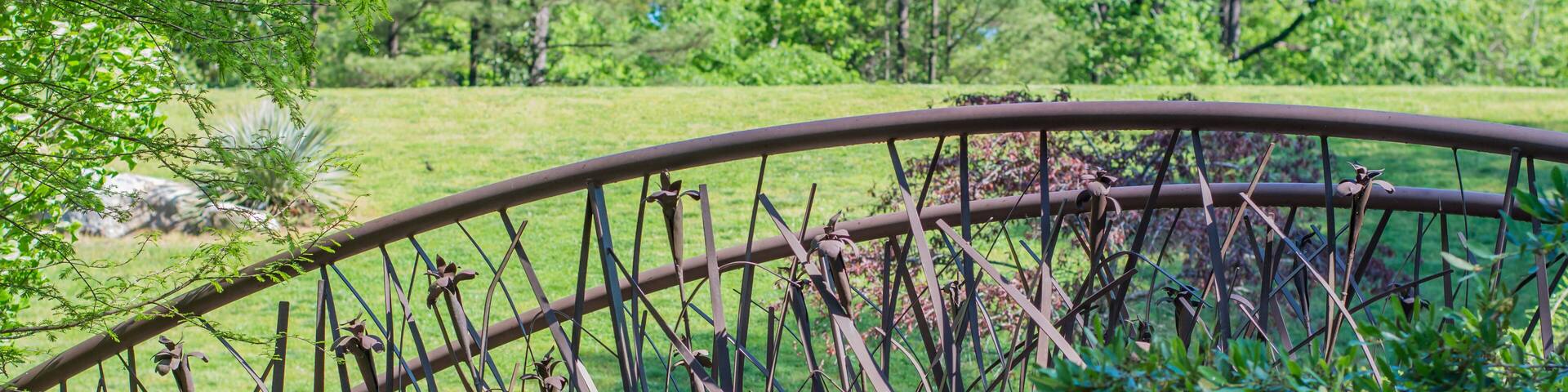 Artistic bridge in green lush garden setting. Sarah P. Duke gardens in Durham, NC.