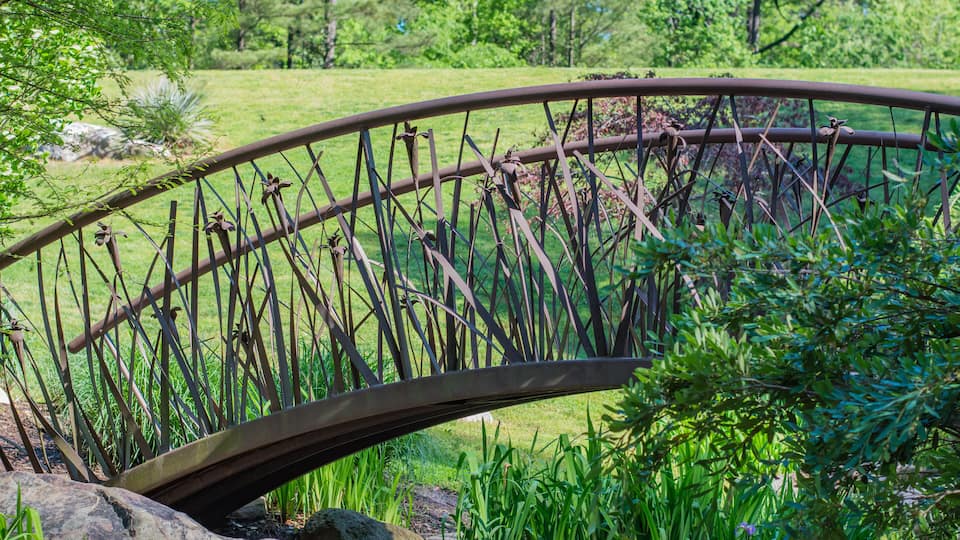 Artistic bridge in green lush garden setting. Sarah P. Duke gardens in Durham, NC.