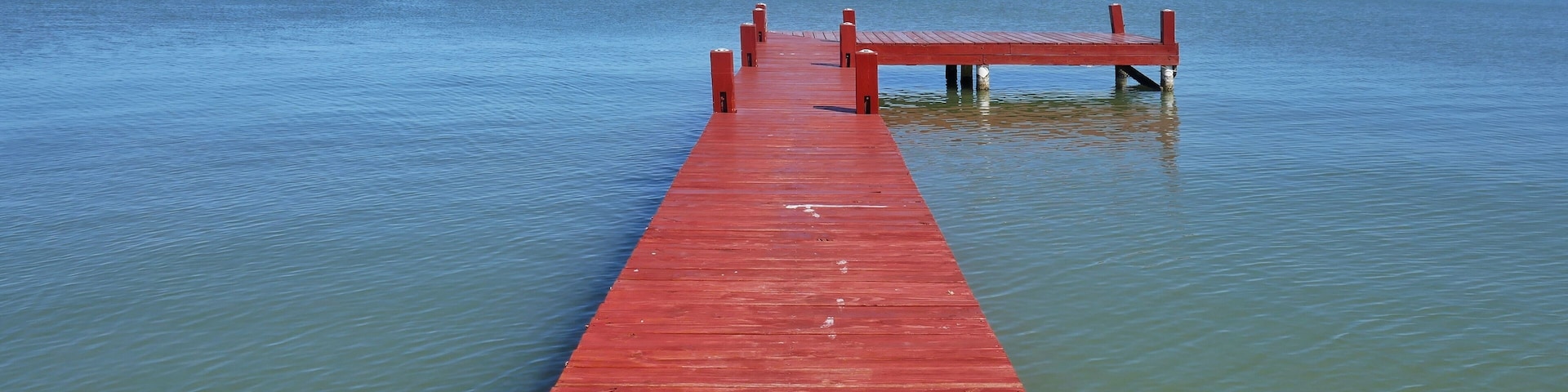 Belize – Red wooden pier at buttonwood bay Belize City