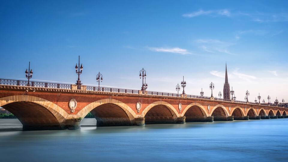 Panorama of Pont de Pierre bridge with St Michel cathedral in Bordeaux, France