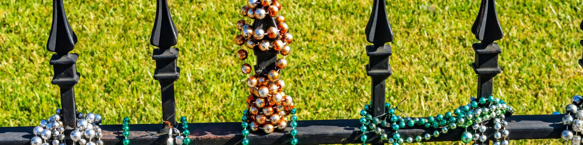 Colorful white, green glass beads, Garden District, New Orleans, Louisiana. Beads handed out at Mardi Gras.