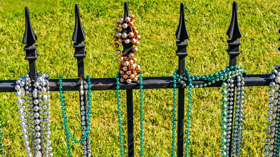 Colorful white, green glass beads, Garden District, New Orleans, Louisiana. Beads handed out at Mardi Gras.