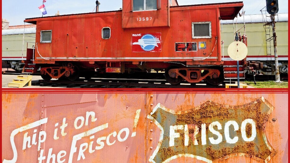 A rusted red train caboose with the number 13597 and a flag on top.