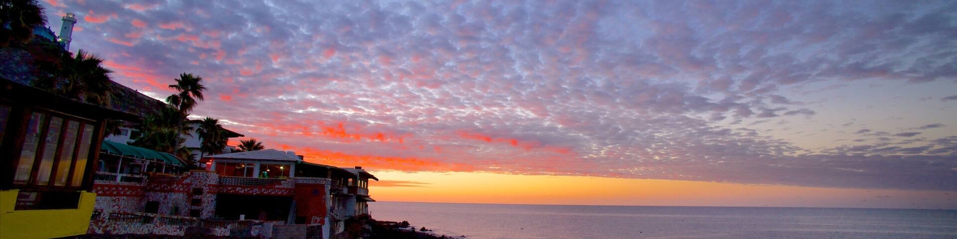 Mexico which includes a coastal town, a sunset and a bay or harbor