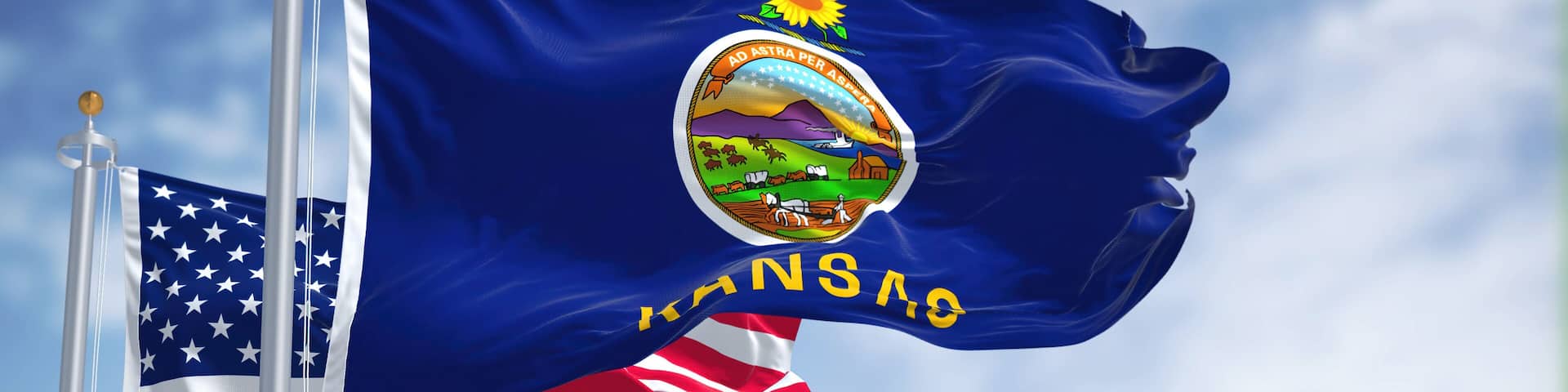 The Kansas state flag waving along with the national flag of the United States of America