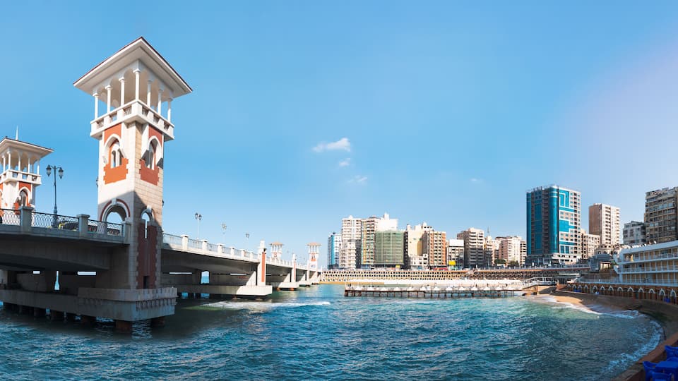 People walk the Stanley Bridge, popular landmark of Alexandria, Egypt